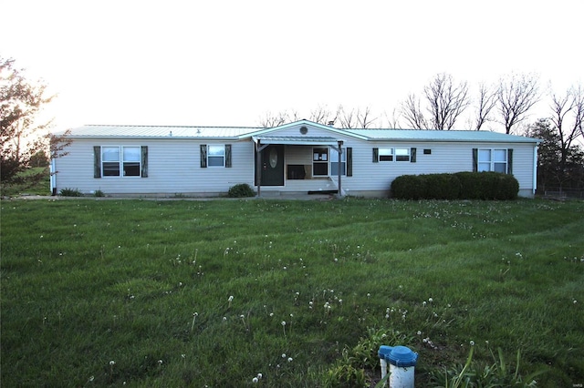 view of front of home featuring a front yard and metal roof