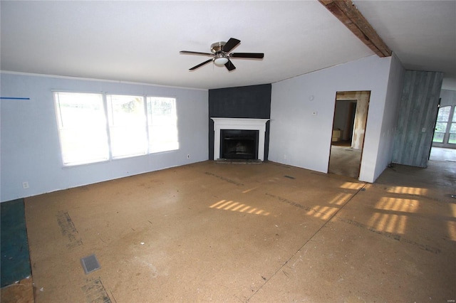 unfurnished living room featuring lofted ceiling with beams, ceiling fan, and a fireplace