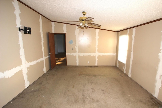 carpeted spare room with crown molding, a ceiling fan, and a textured ceiling