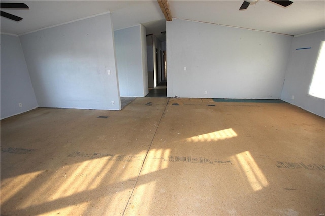 spare room featuring ceiling fan and beam ceiling