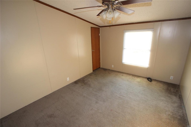 spare room featuring light colored carpet, ornamental molding, a ceiling fan, and lofted ceiling