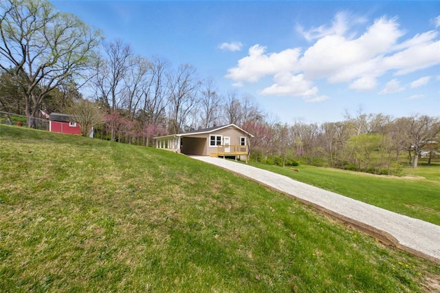 view of front of property with a carport, driveway, and a front yard
