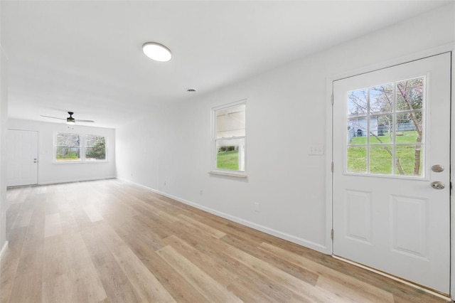 interior space with light wood-style floors, baseboards, and ceiling fan