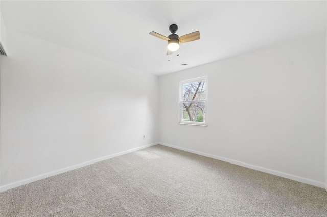 unfurnished room featuring a ceiling fan, baseboards, and light colored carpet