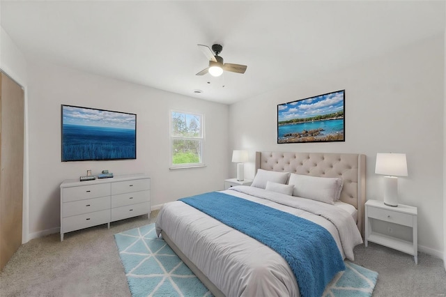 bedroom featuring ceiling fan, baseboards, and light colored carpet