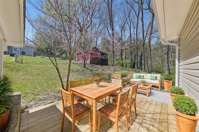 view of patio with an outdoor living space, outdoor dining area, fence, and a deck
