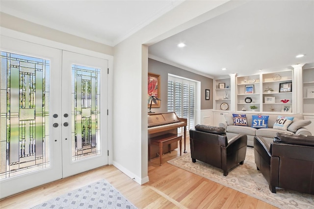 interior space featuring ornamental molding, a healthy amount of sunlight, and french doors