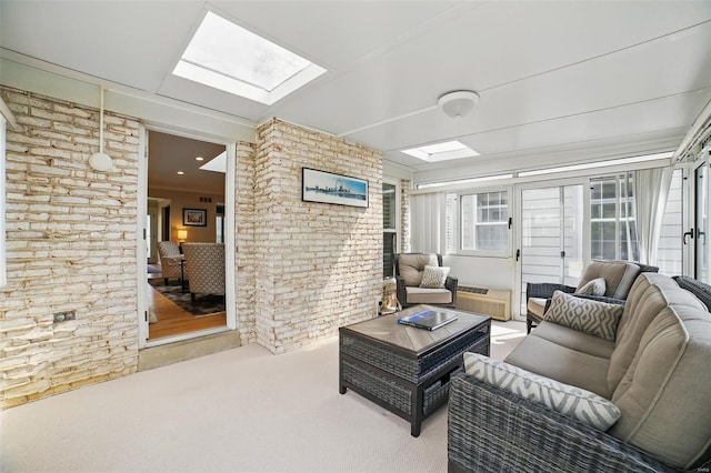 living room with a skylight and carpet flooring