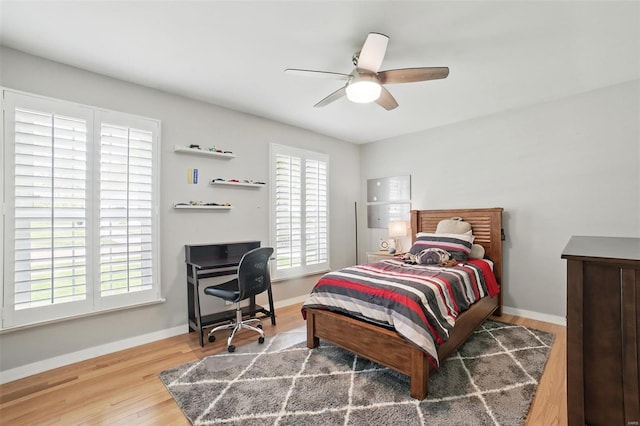 bedroom featuring wood finished floors, ceiling fan, and baseboards