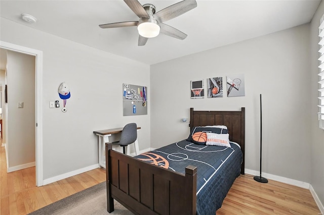 bedroom featuring ceiling fan, wood finished floors, and baseboards