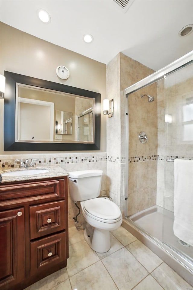 full bath featuring tile patterned floors, a shower stall, and vanity