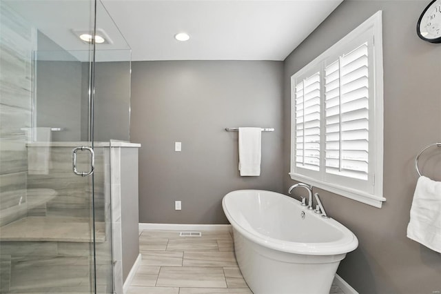 full bathroom featuring recessed lighting, a shower stall, visible vents, baseboards, and a soaking tub