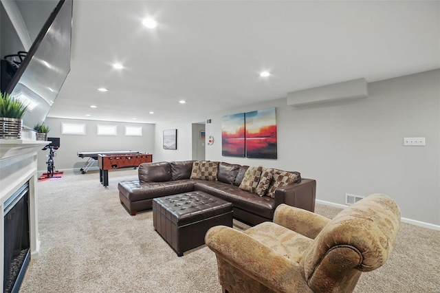 carpeted living area featuring recessed lighting, visible vents, baseboards, and a fireplace