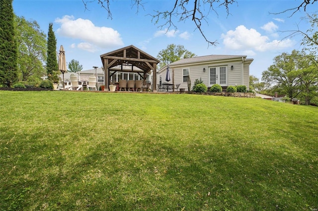 rear view of house with a gazebo and a yard