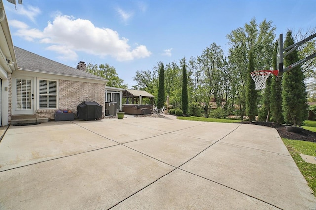 view of patio featuring a grill and a hot tub