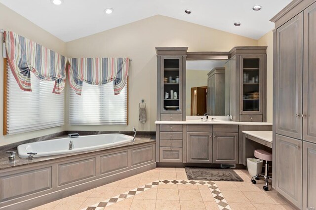 full bath with vaulted ceiling, tile patterned floors, a bath, vanity, and recessed lighting