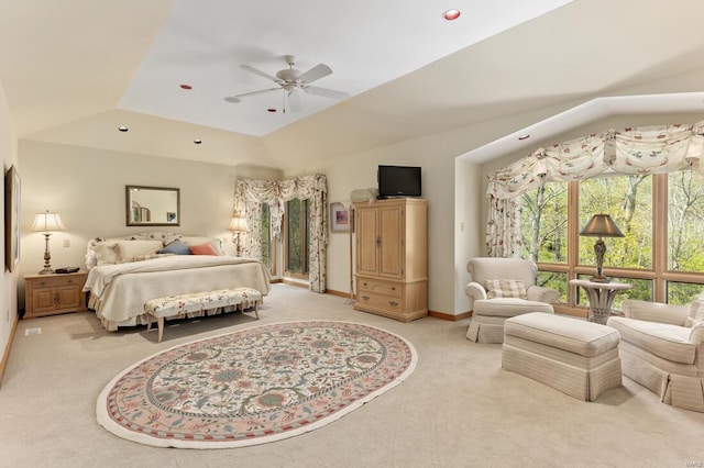 bedroom featuring a ceiling fan, light carpet, lofted ceiling, and baseboards