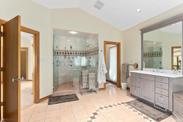 full bath with a shower stall, tile patterned floors, vaulted ceiling, visible vents, and vanity