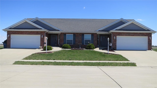 view of front of home featuring concrete driveway, an attached garage, brick siding, and a front lawn
