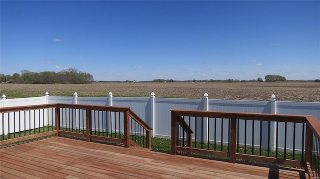 deck with fence and a rural view