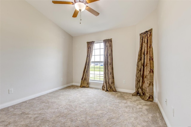 spare room featuring baseboards, carpet flooring, and ceiling fan