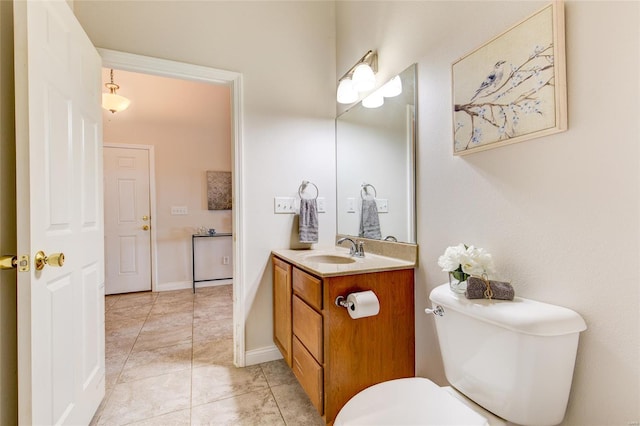bathroom featuring tile patterned flooring, toilet, and vanity