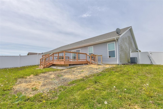 rear view of house featuring a fenced backyard, central AC unit, a yard, and a deck