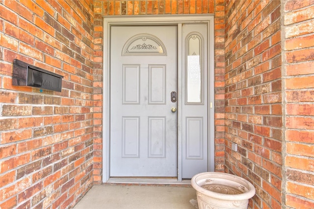 entrance to property with brick siding