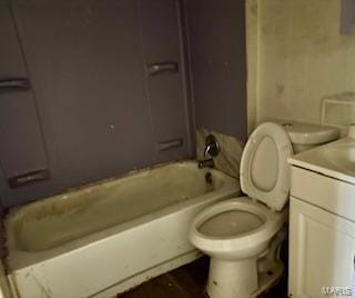 bathroom with shower / bathing tub combination, vanity, and toilet
