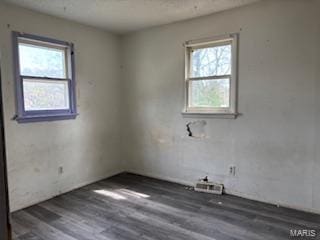 spare room featuring wood finished floors