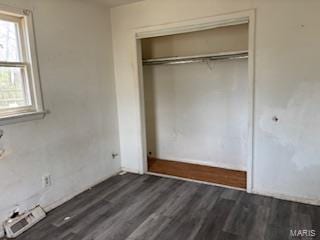 unfurnished bedroom featuring wood finished floors and a closet