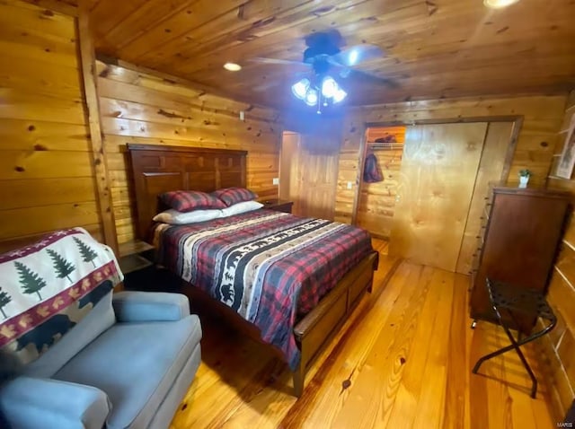 bedroom with wooden walls, wooden ceiling, and hardwood / wood-style floors