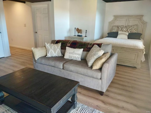 living area with baseboards and light wood-type flooring