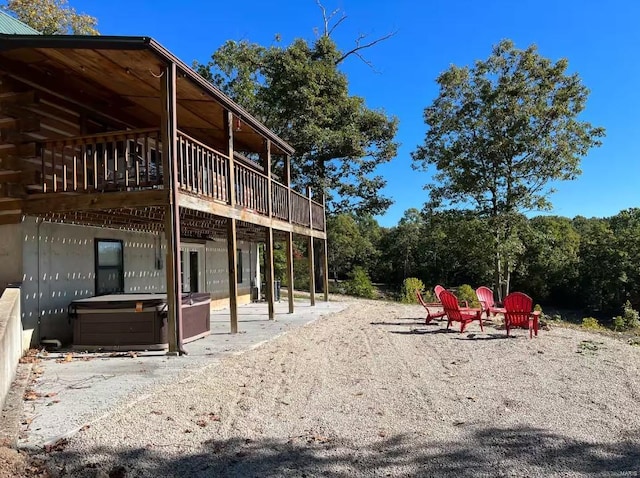 exterior space featuring a patio, a jacuzzi, and a wooden deck