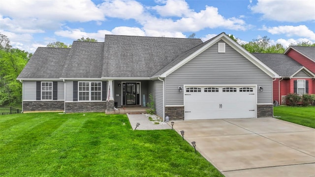 view of front of property with an attached garage, a front lawn, stone siding, and concrete driveway