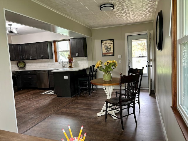 interior space featuring baseboards, dark wood finished floors, and crown molding
