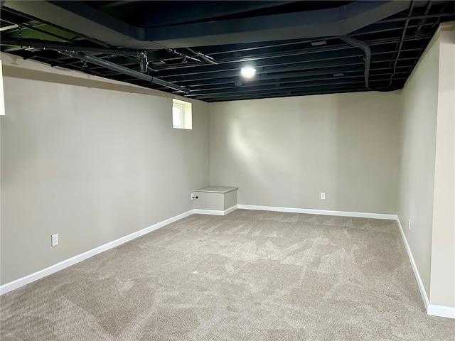 below grade area with carpet flooring and baseboards