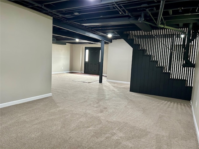 finished basement featuring baseboards, carpet floors, and stairs
