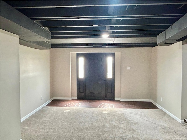 carpeted foyer entrance featuring baseboards