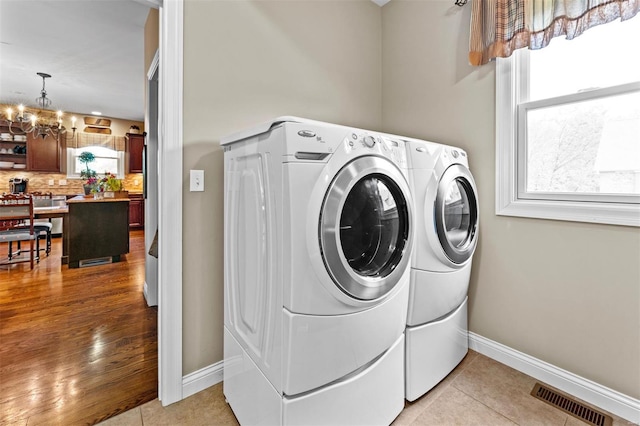 laundry room with visible vents, a chandelier, laundry area, and washing machine and dryer