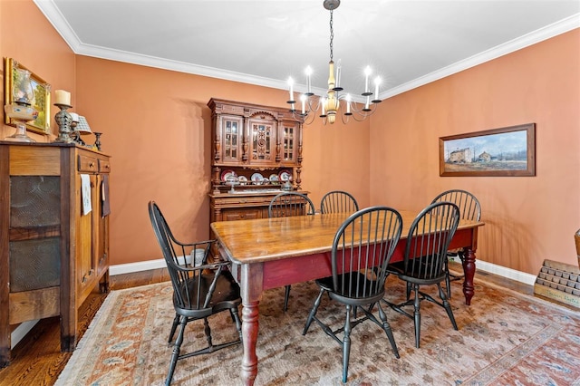 dining room featuring an inviting chandelier, wood finished floors, ornamental molding, and baseboards