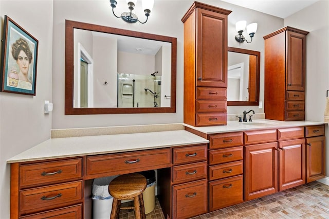 full bathroom with a shower with shower door and vanity