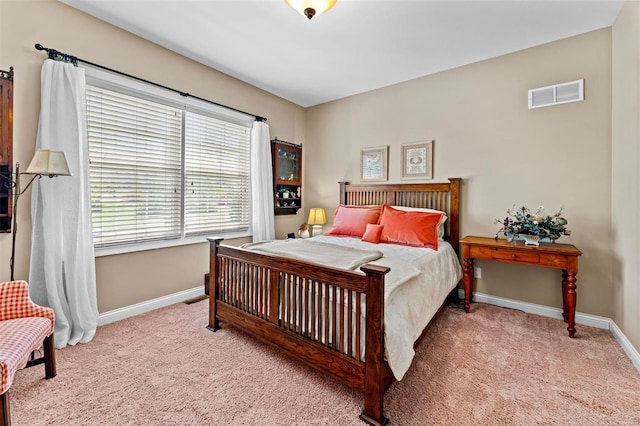 bedroom with visible vents, carpet floors, and baseboards