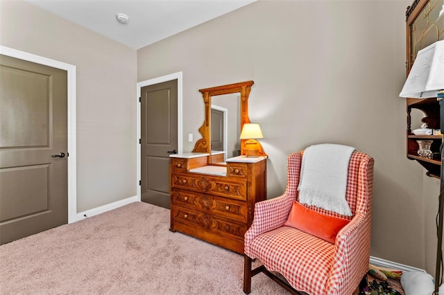 living area featuring carpet flooring and baseboards