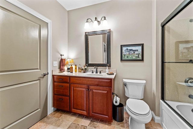 bathroom featuring toilet, shower / bath combination with glass door, vanity, and baseboards