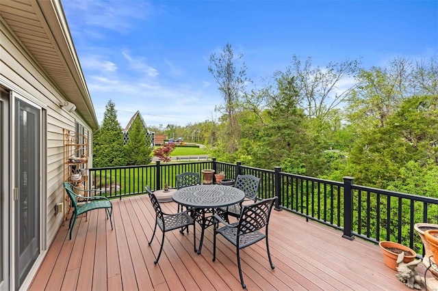 wooden terrace featuring outdoor dining area