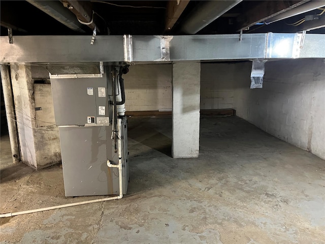 unfinished below grade area featuring heating unit