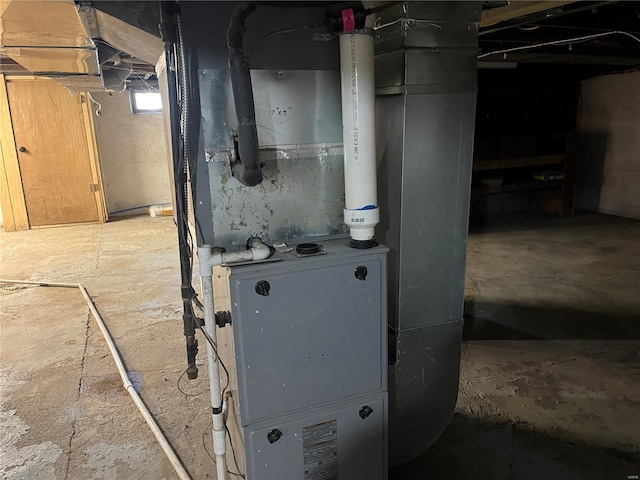 utility room featuring heating unit