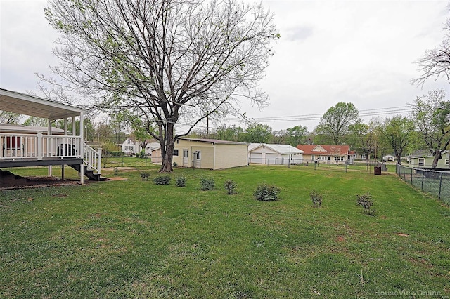 view of yard featuring fence, a deck, and stairs