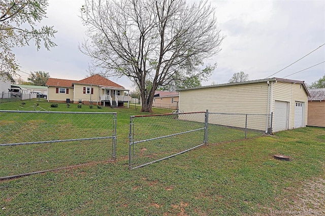 view of yard featuring a fenced backyard, a gate, and a garage